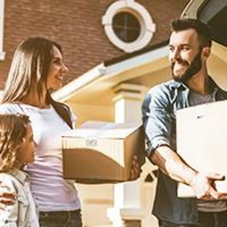 family packing moving boxes into car