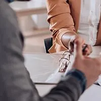 couple meeting with mortgage lender to look at paperwork