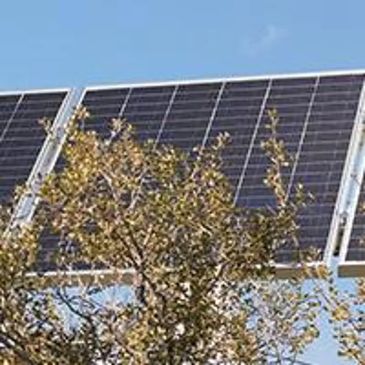 man installing solar panels on roof