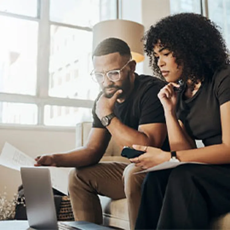serious looking couple studying loan options