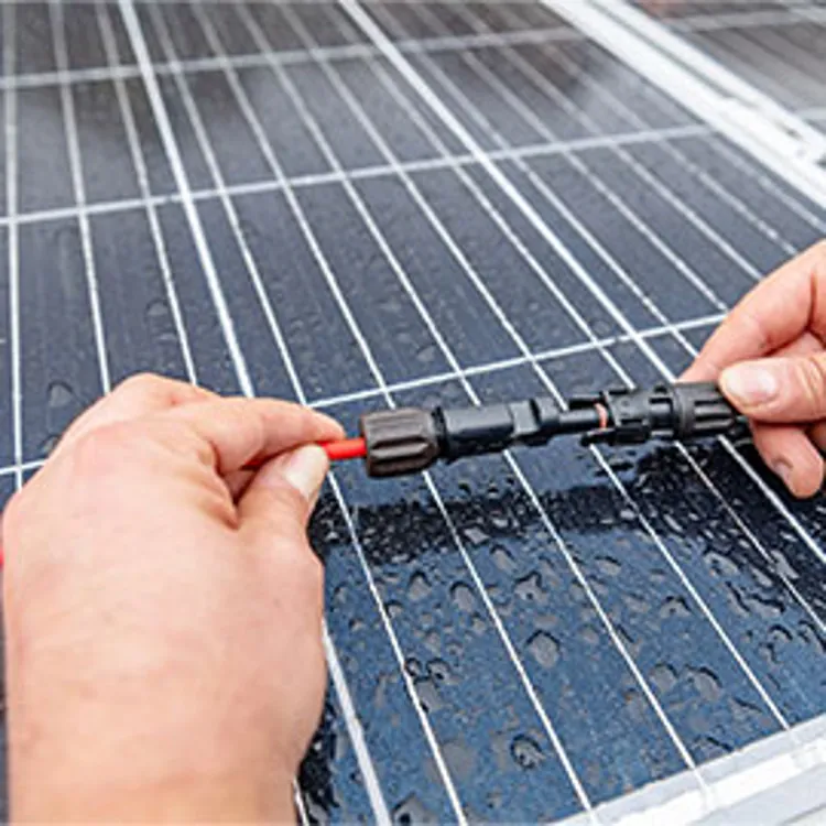 hands of a tech connecting solar panels
