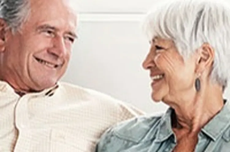 senior couple sitting on sofa