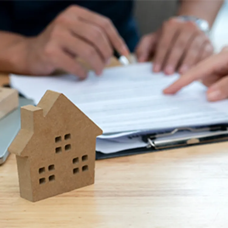 couple looking at paperwork to buy home