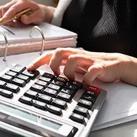 accountant woman working in binder and calculator