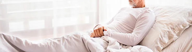 senior man laying in adjustable bed