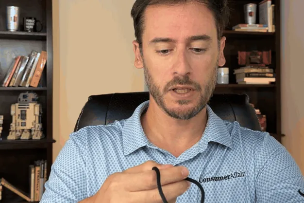 Chris Kolmar adjusting the ADT On-the-Go pendant's lanyard and plastic clasp
