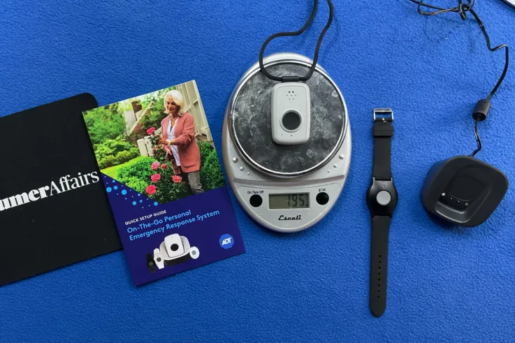 ADT On-the-Go pendant being weighed on a kitchen scale