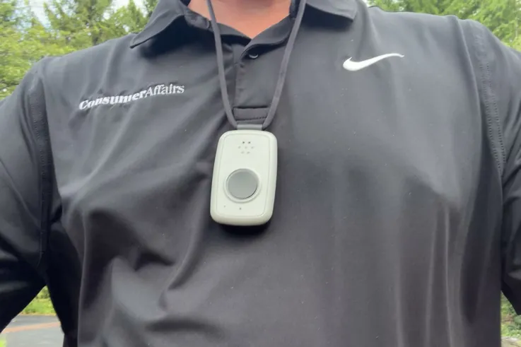 ADT On-the-Go pendant hanging on its lanyard at mid-chest, worn outdoors
