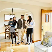 family walking through a house with a realtor