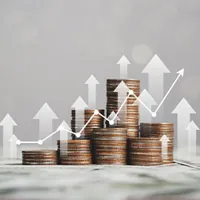stack of coins in varying height with upward arrows and graph showing upward trend