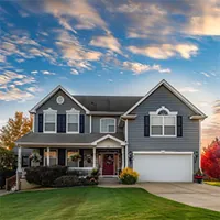 two-story home with veranda and garage