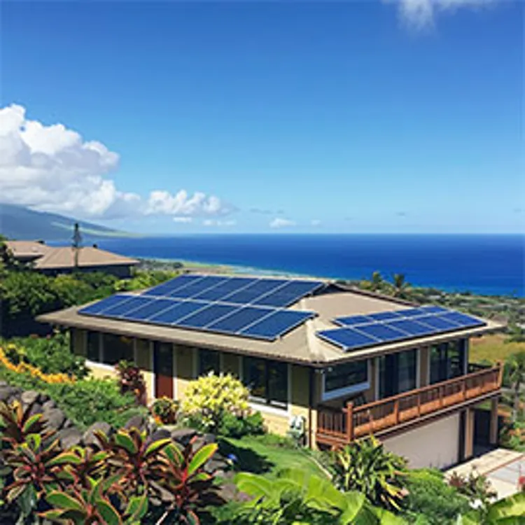 two-story home near the sea in hawaii with solar panels on the roof