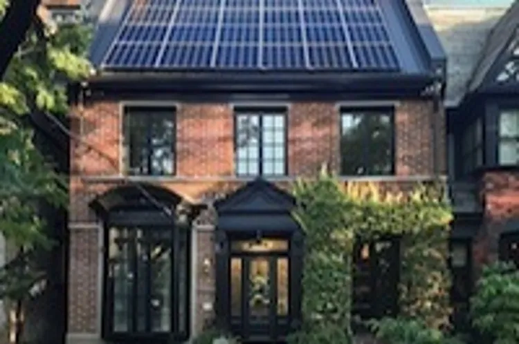 a row house with solar panels on the roof