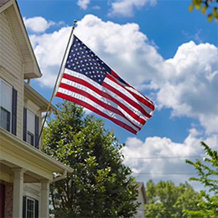 house with american flag displayed on top of a portico