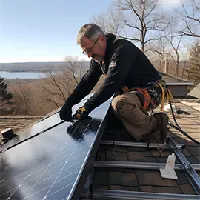 man installing solar panels on building roof