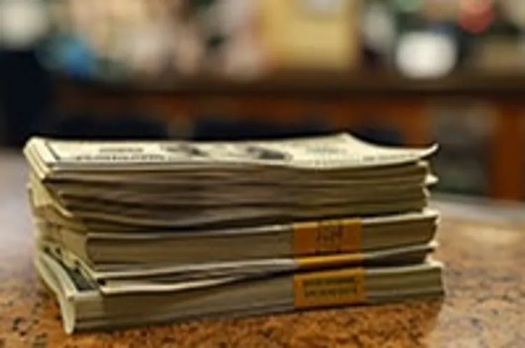 a stack of dollar bills on a counter