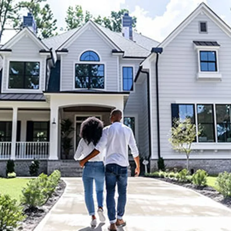 a couple in front of a house