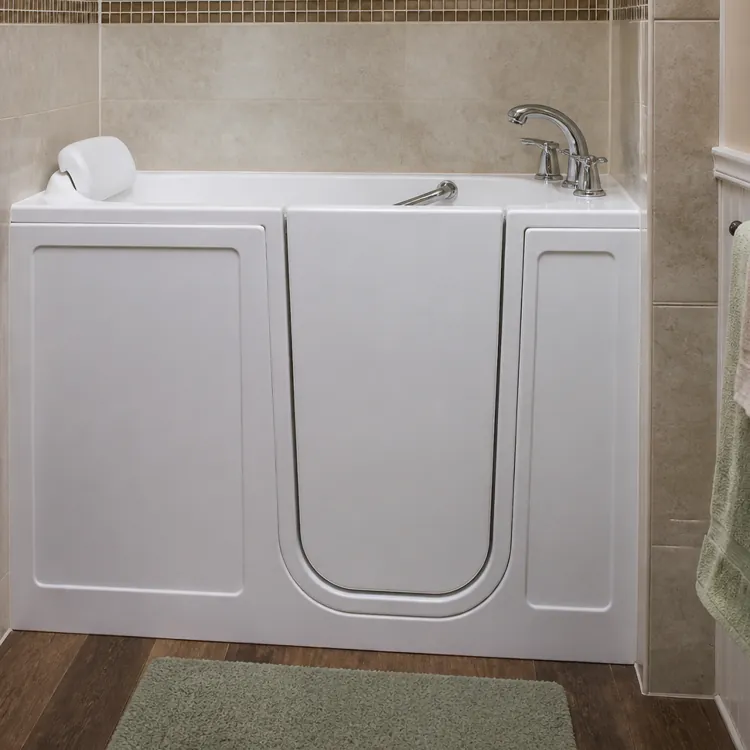 Walk-in bathtub with a door, faucet, and towel racks in a bathroom with shelves and towels
