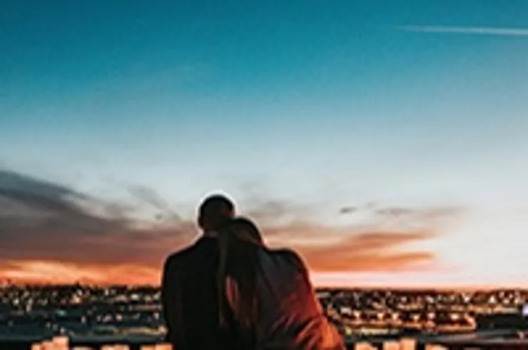 couple watching the city sunset