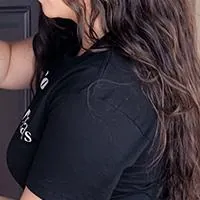 woman installing doorbell camera on her house