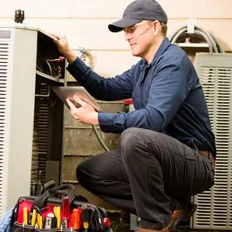 repairman working on air conditioning unit