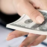 woman handing man cash