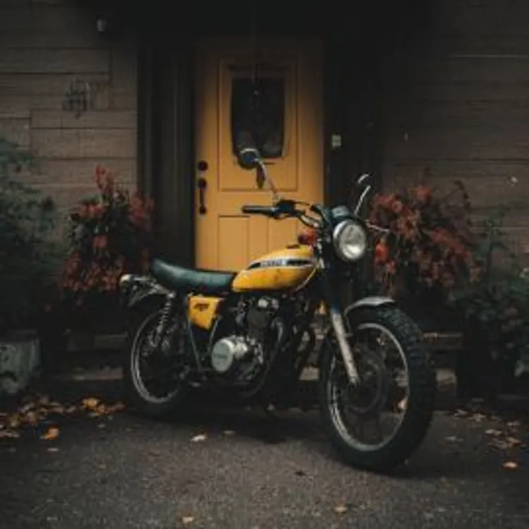 black and yellow motorcycle in front of a house with a yellow door