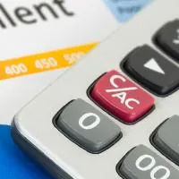 partial image of a calculator over a personal loan application form and an excellent credit score report under the form