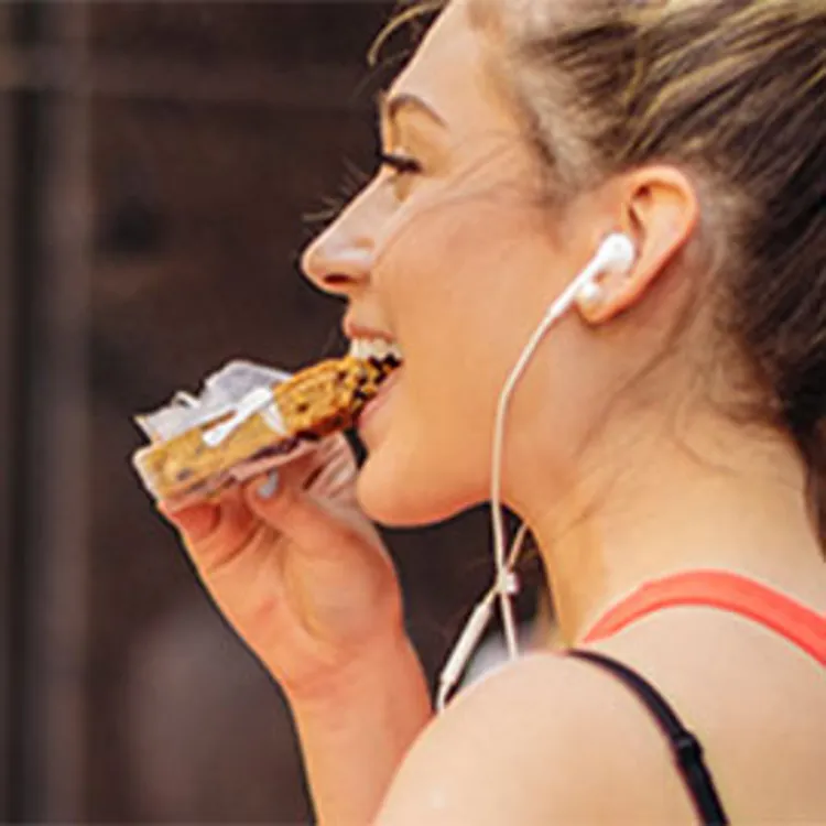 girl eating a protein bar