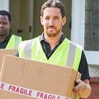 two moving personnel carrying boxes