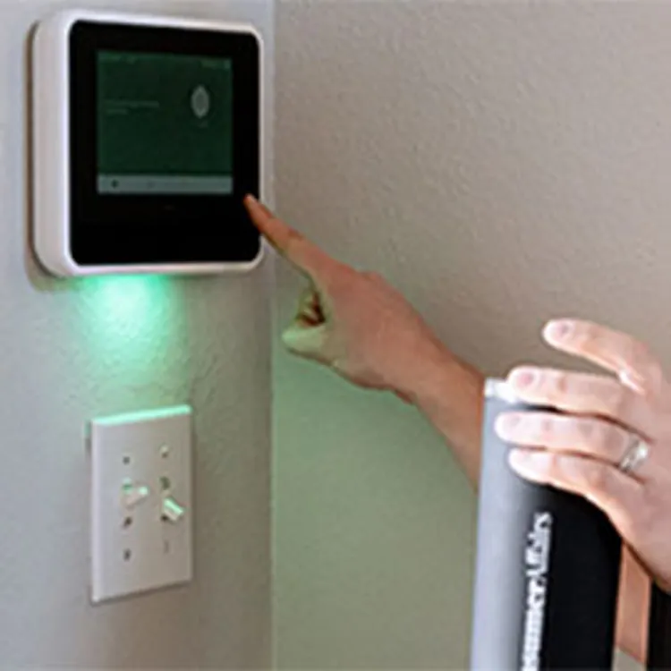 woman alarming her security system from her smart panel