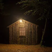wooden shed with light at night