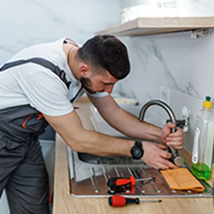 man fixing water pipes
