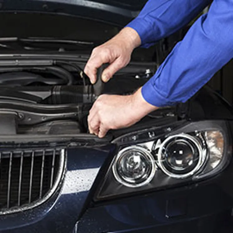 a mechanic using a screwdriver on a bmw