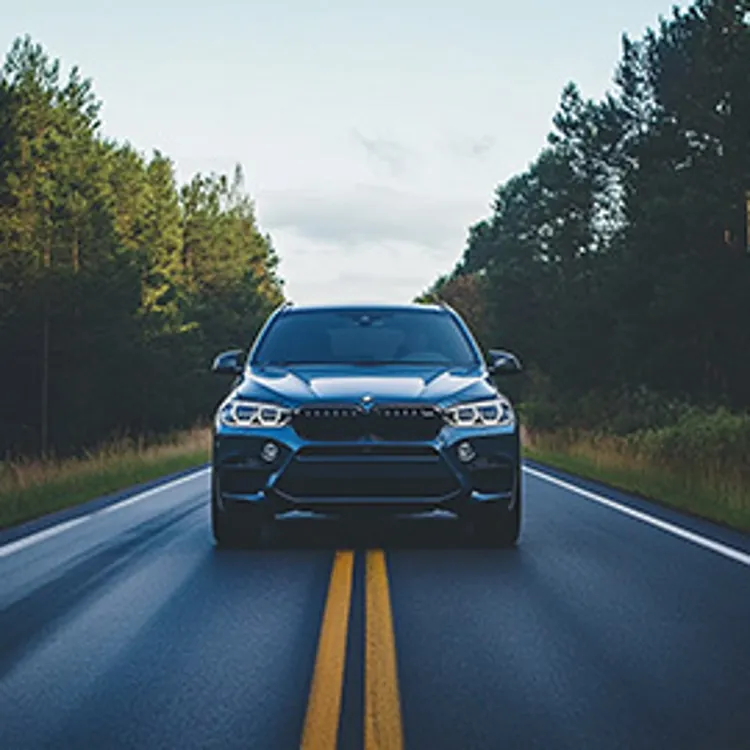 blue suv in the middle of a road