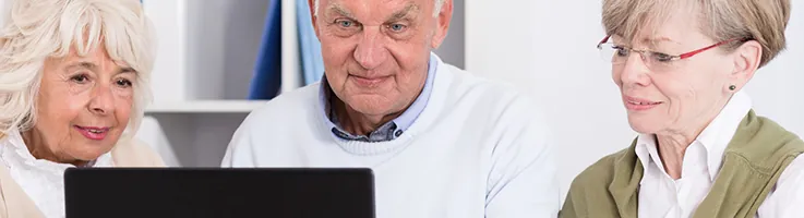 older adults looking at laptop
