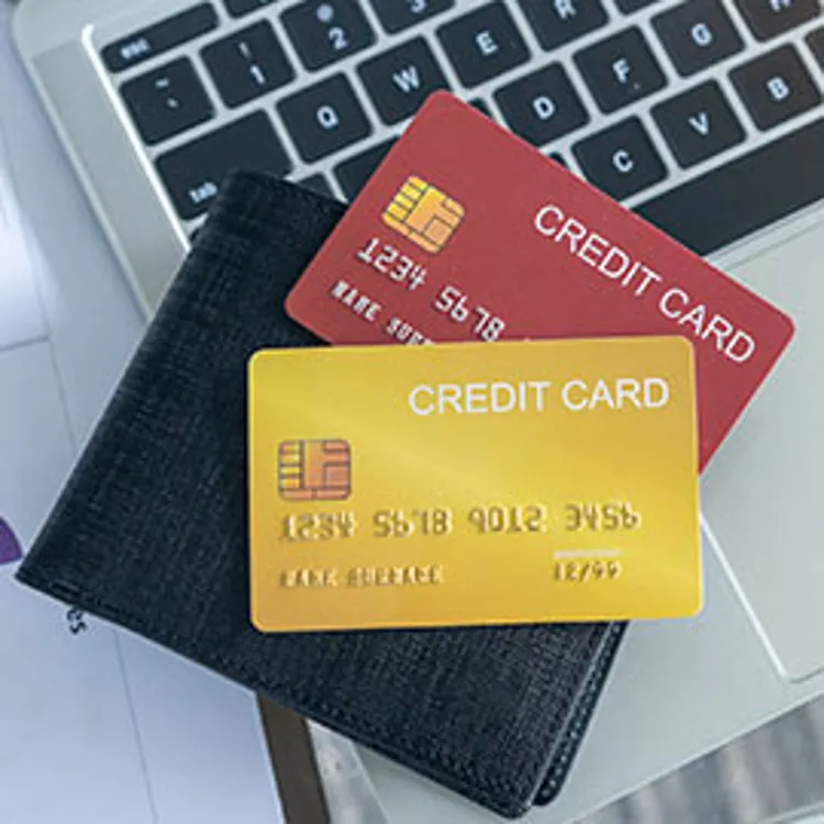 credit cards on top of a laptop