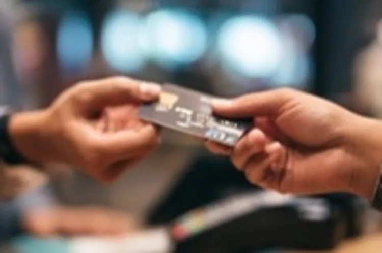 a credit card being handed over to someone