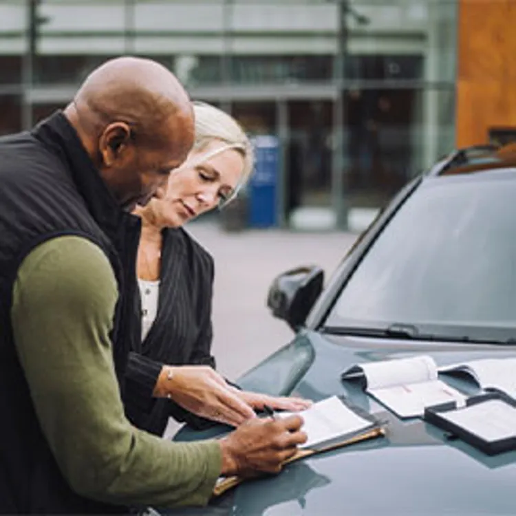 lady rep assisting male client signing paperwork on a loan