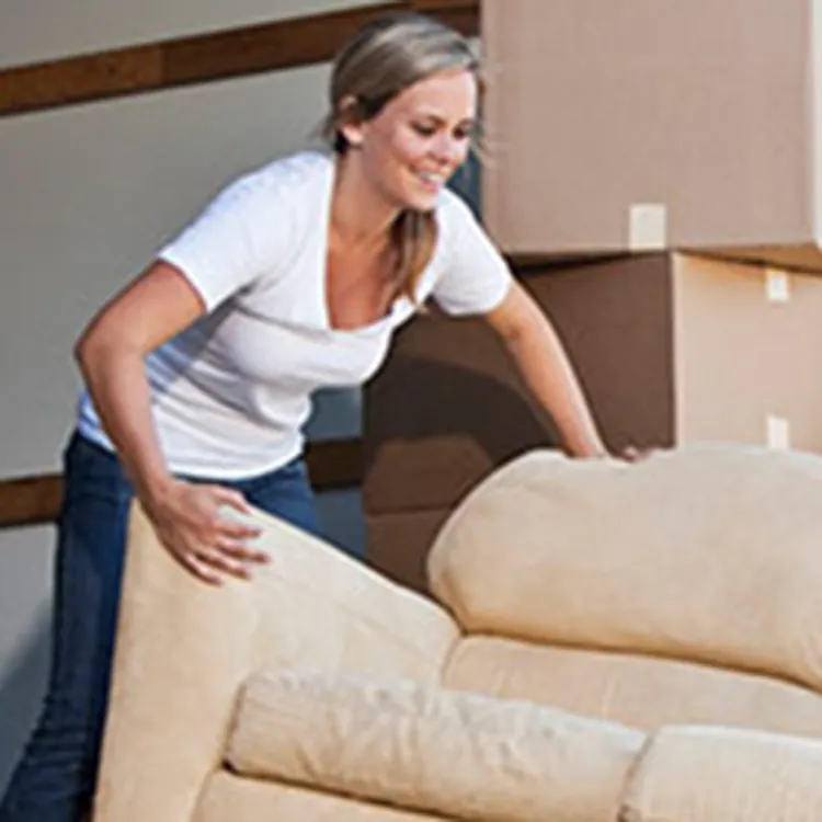 man and woman moving a couch