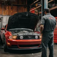 mechanic looking at a car