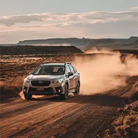 car travelling on a dusty dessert road