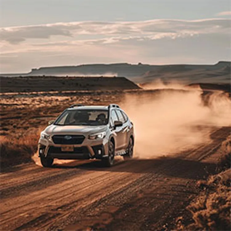 car travelling on a dusty dessert road