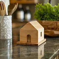miniature wooden house on dark marble kitchen counter