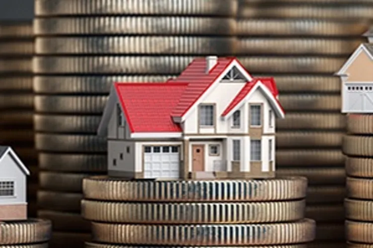 little houses sitting on stacks of coins