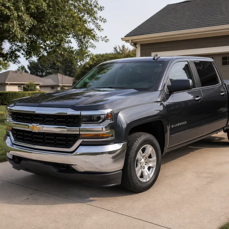 Gray pickup truck parked on a concrete driveway in front of a suburban house