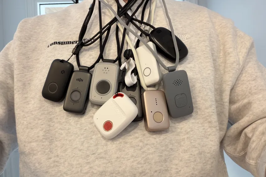 Chris Kolmar wearing nine medical alert pendants on lanyards around his neck over a white sweater
