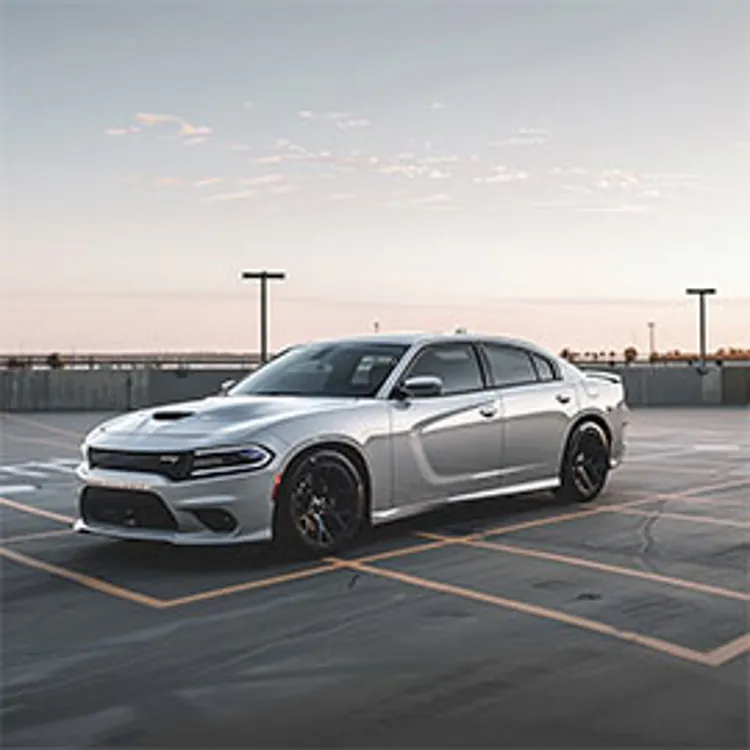 a silver chrysler parked in an empty parking lot