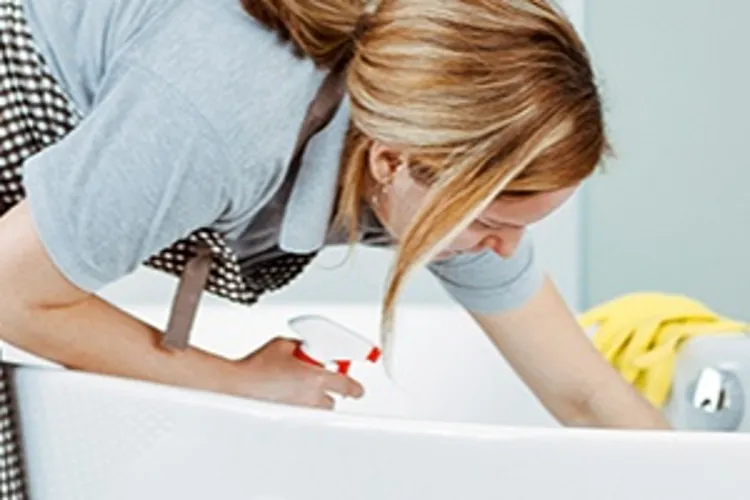 woman cleaning a bathtub