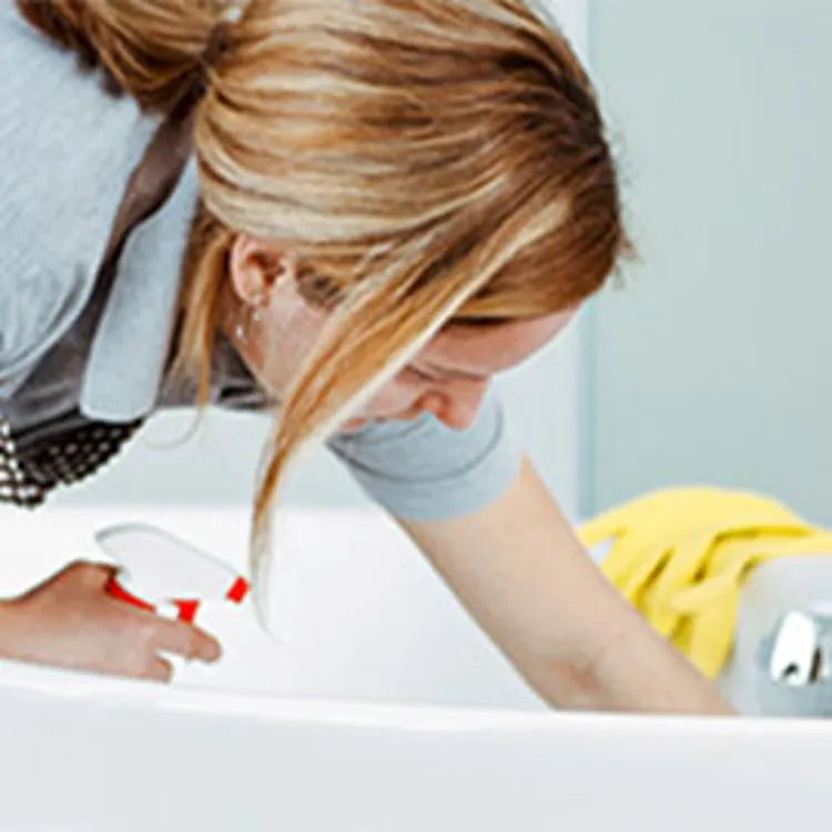 woman cleaning a bathtub